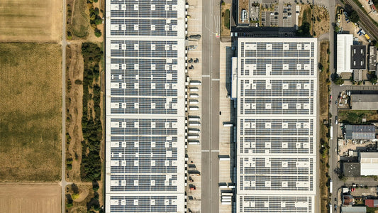 Vista aérea de dos naves industriales con paneles solares en el techo